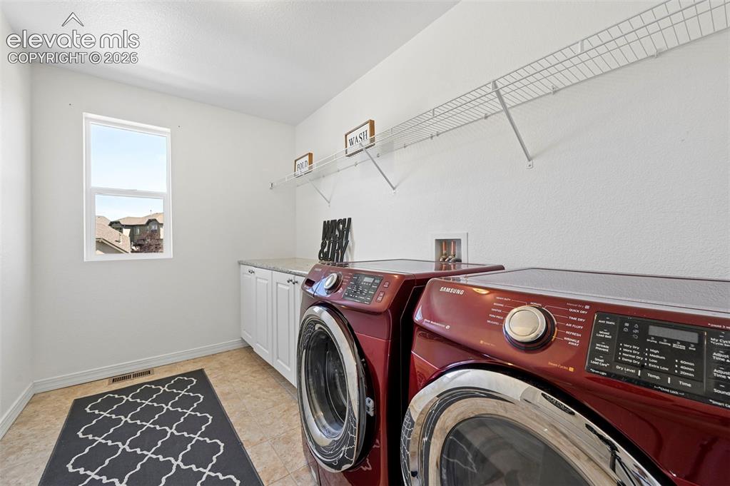 Image 50 of 50: Utility room with white cabinetry, a light-colored countertop, and a single