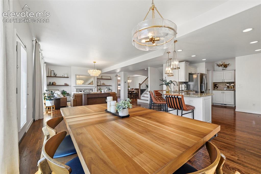 Image 9 of 50: Hardwood flooring, kitchen island with seating, pendant lighting, built-in