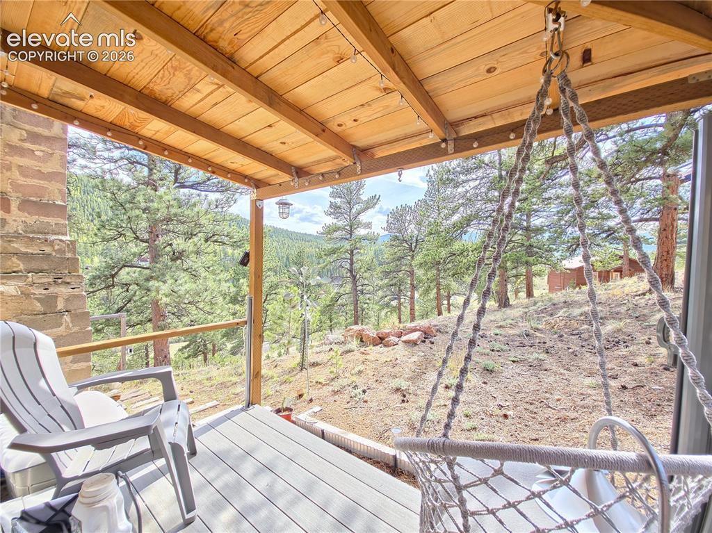 Image 3 of 24: Deck/Porch added on w/ roof and privacy shades installed