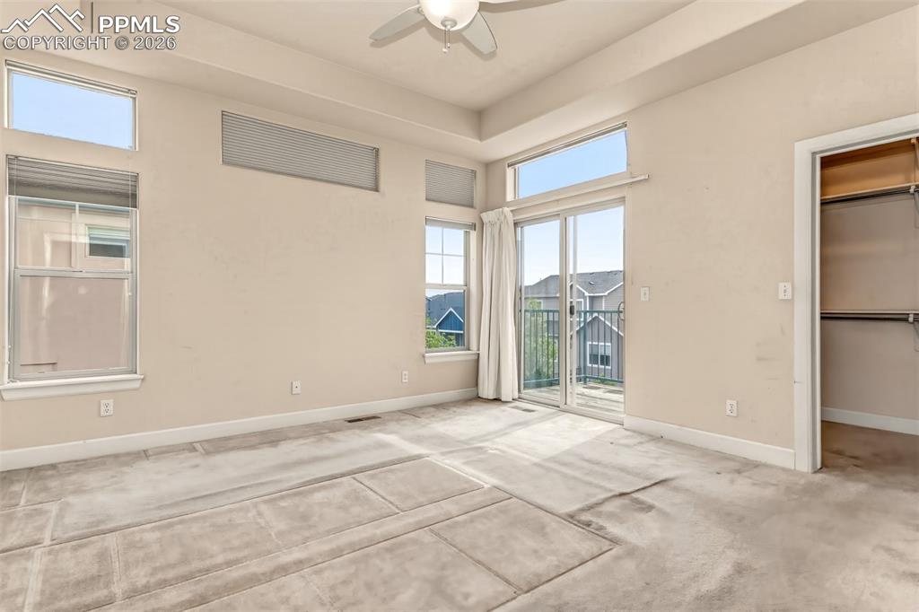 Image 11 of 34: Primary bedroom with walk out deck, walk in closet and en suite bathroom 