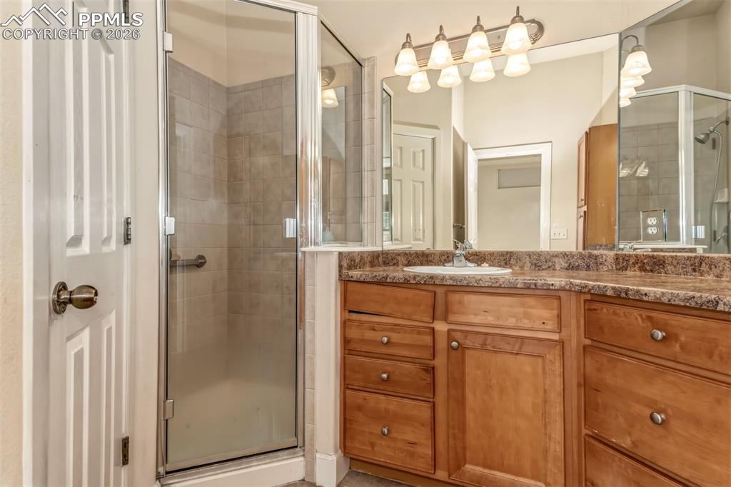 Image 14 of 34: En suite primary bathroom with stand in shower and dual sinks