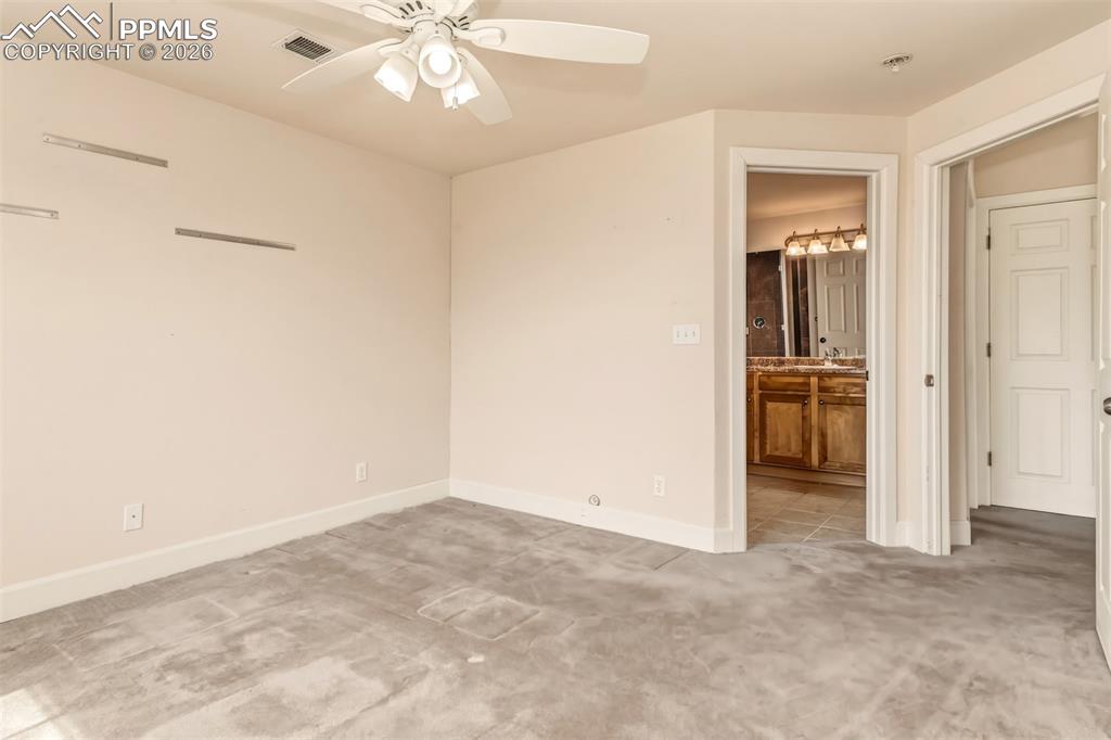 Image 22 of 34: Bedroom 3 on the lower level with connecting 3/4 bathroom