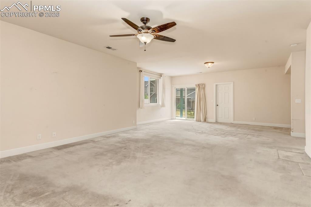 Image 25 of 34: Recreation room on lower level with walk out to covered patio