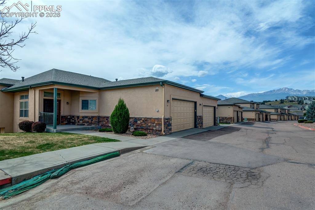 Image 30 of 34: Front view of the townhome. Notice Pikes Peak in the back!!!