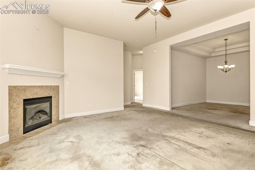 Image 7 of 34: Living room with gas fireplace looking to dining room