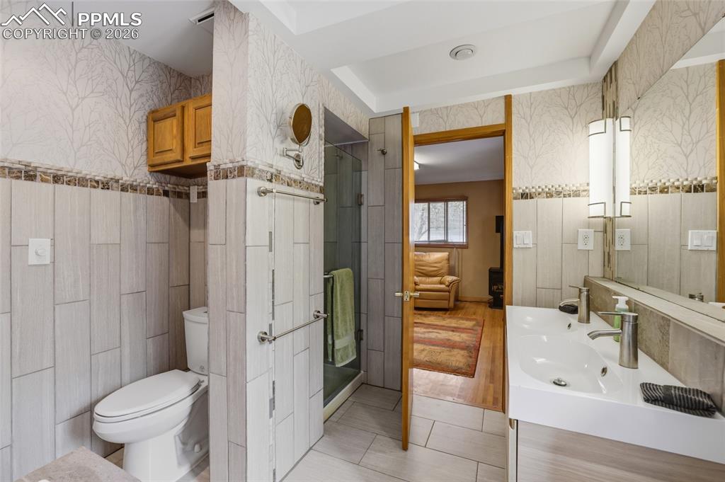 Image 19 of 50: Primary bedroom has walk-out to back yard and private deck