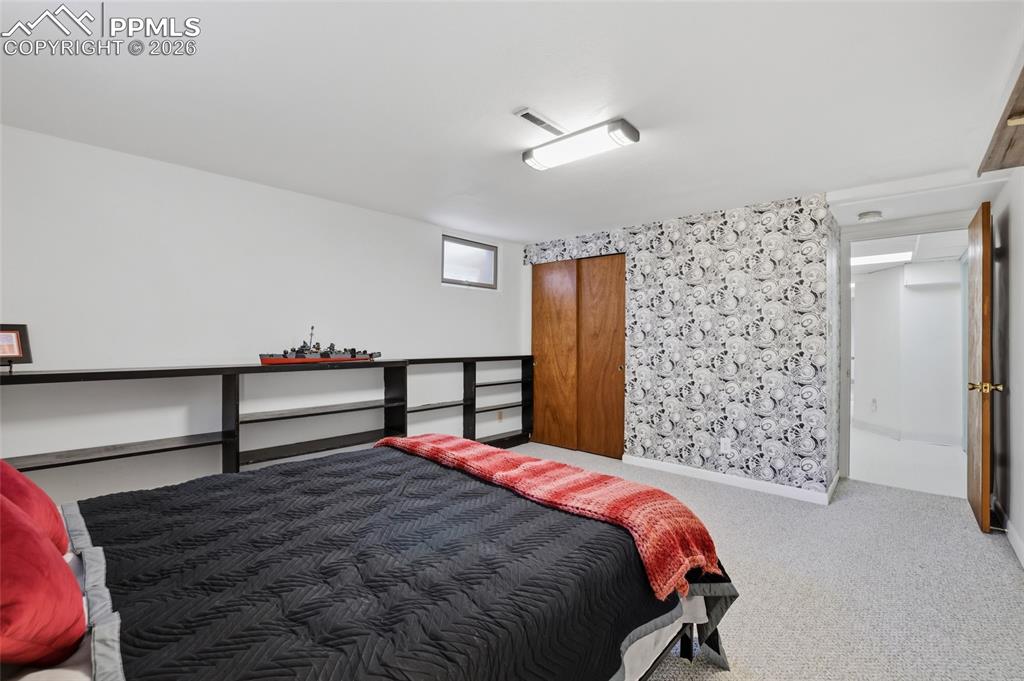 Image 31 of 50: Spacious laundry room with sink and drop-down folding table