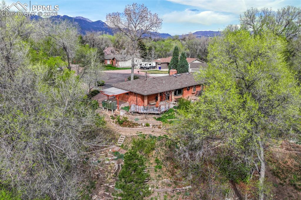 Image 45 of 50: Back yard with garage door on left and primary bedroom door on right
