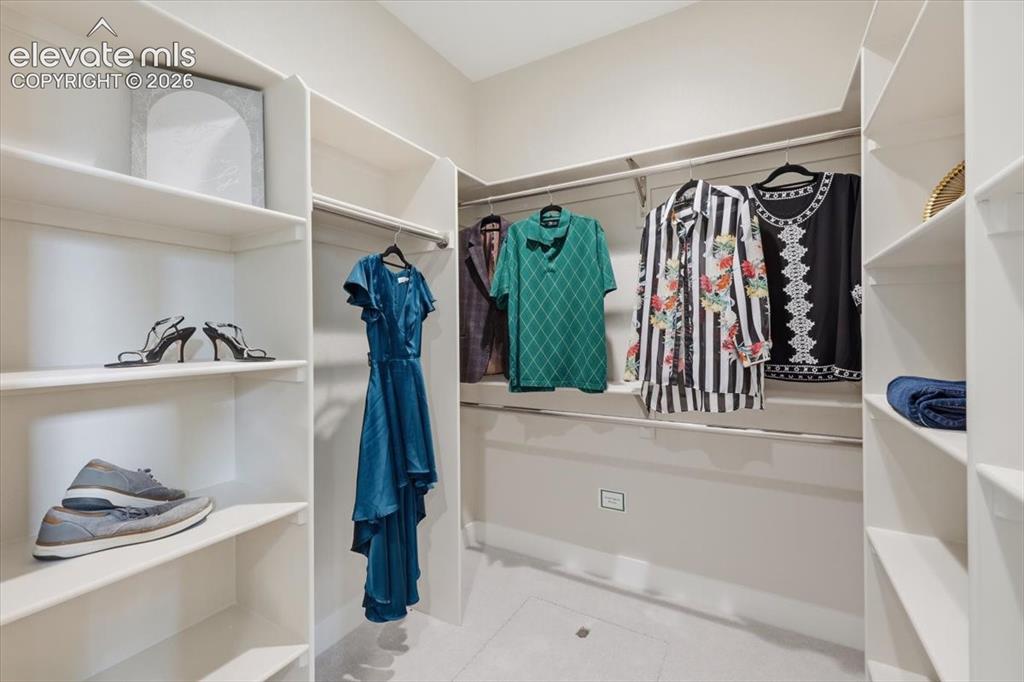 Image 11 of 18: Primary Suite Walk-in Closet with Custom Built-ins.