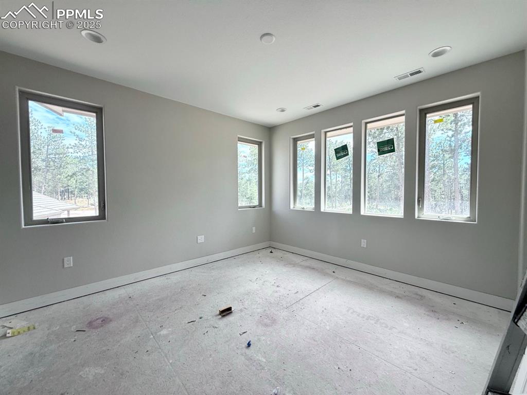 Image 14 of 23: Main Level Primary Suite, Carpeted, En-suite.
