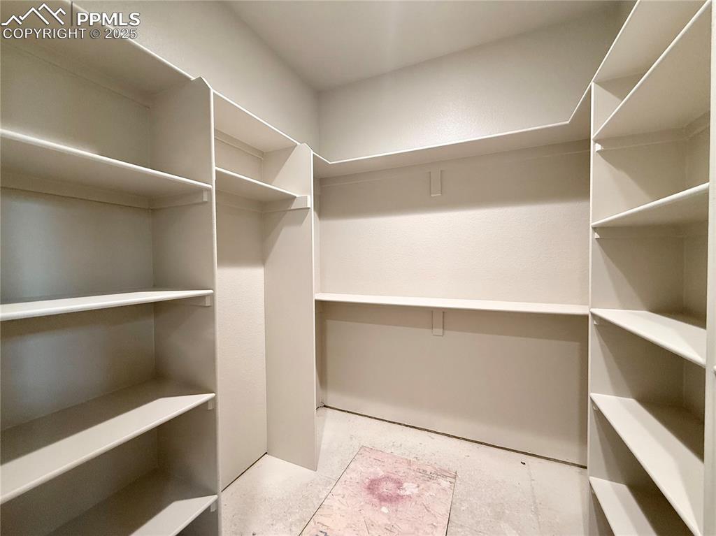 Image 15 of 23: Walk-in Closet with Built-ins