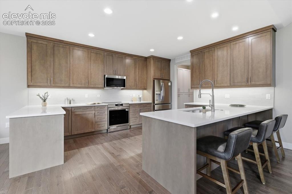 Image 8 of 18: Gourmet Kitchen with Quartz Countertops, Stainless Steel Appliances, and In