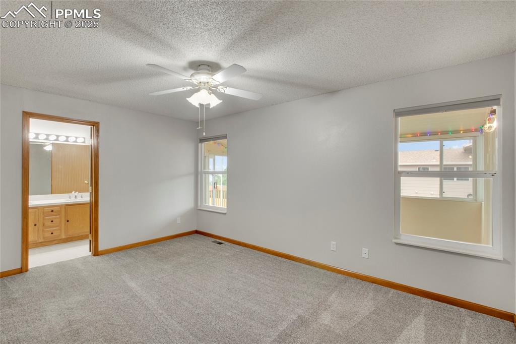 Image 12 of 27: Primary bedroom and ensuite bath