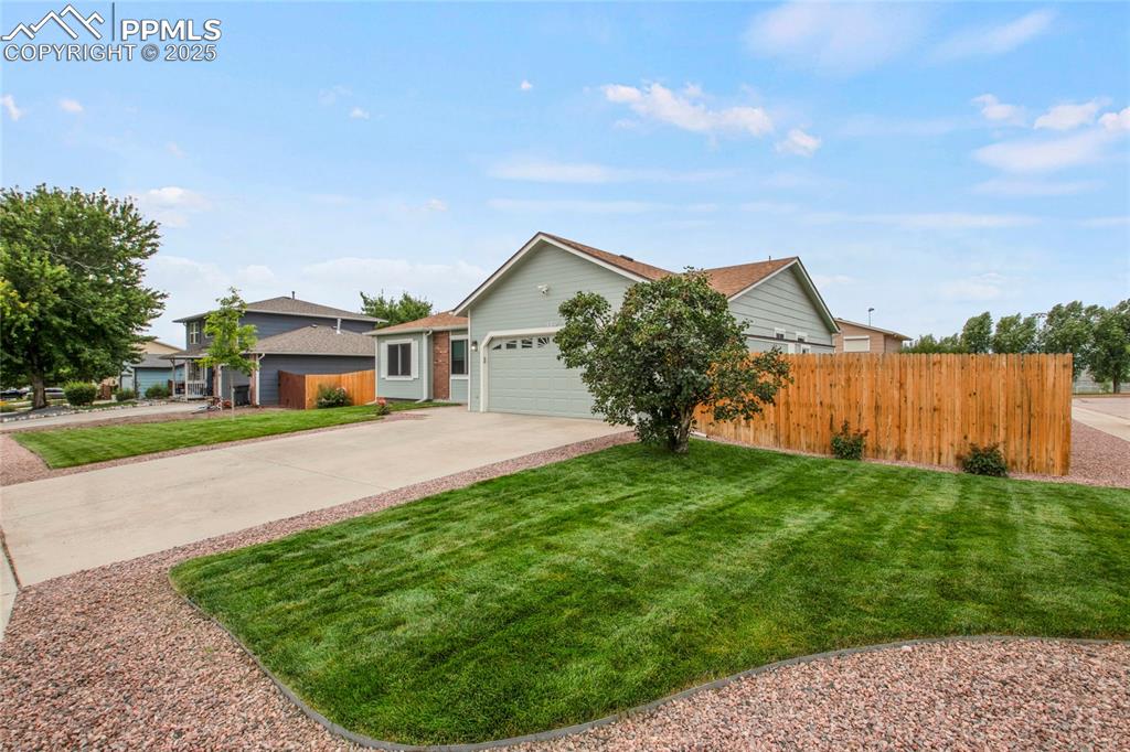 Image 2 of 27: Ranch-style home with driveway and a oversized 2 car garage