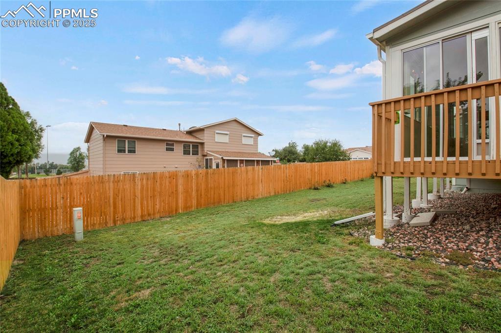 Image 26 of 27: View of fenced backyard