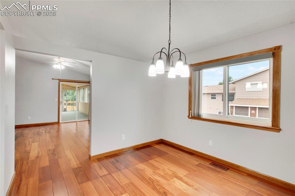 Image 5 of 27: Spare room with light wood-style flooring, healthy amount of natural light,