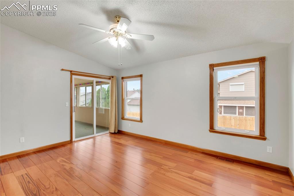 Image 6 of 27: Unfurnished bedroom featuring light wood-type flooring, access to exterior,