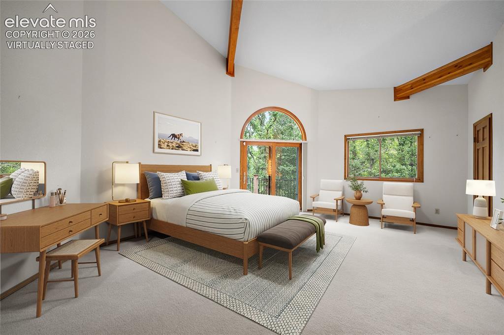 Image 25 of 49: Virtually staged photo of primary bedroom featuring a walkout to the deck