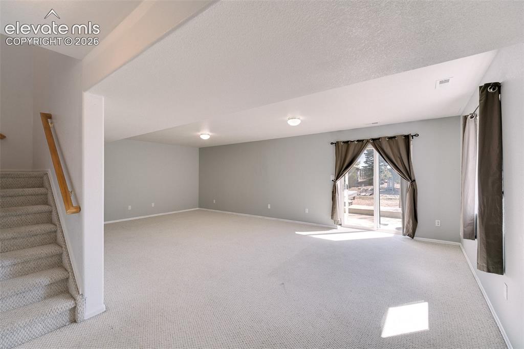 Image 10 of 50: Finished Basement with large, walk out Family Room.