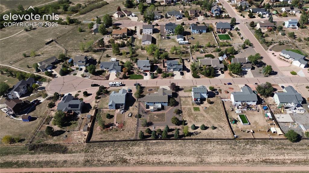Image 12 of 50: Aerial view of home and neighborhood.