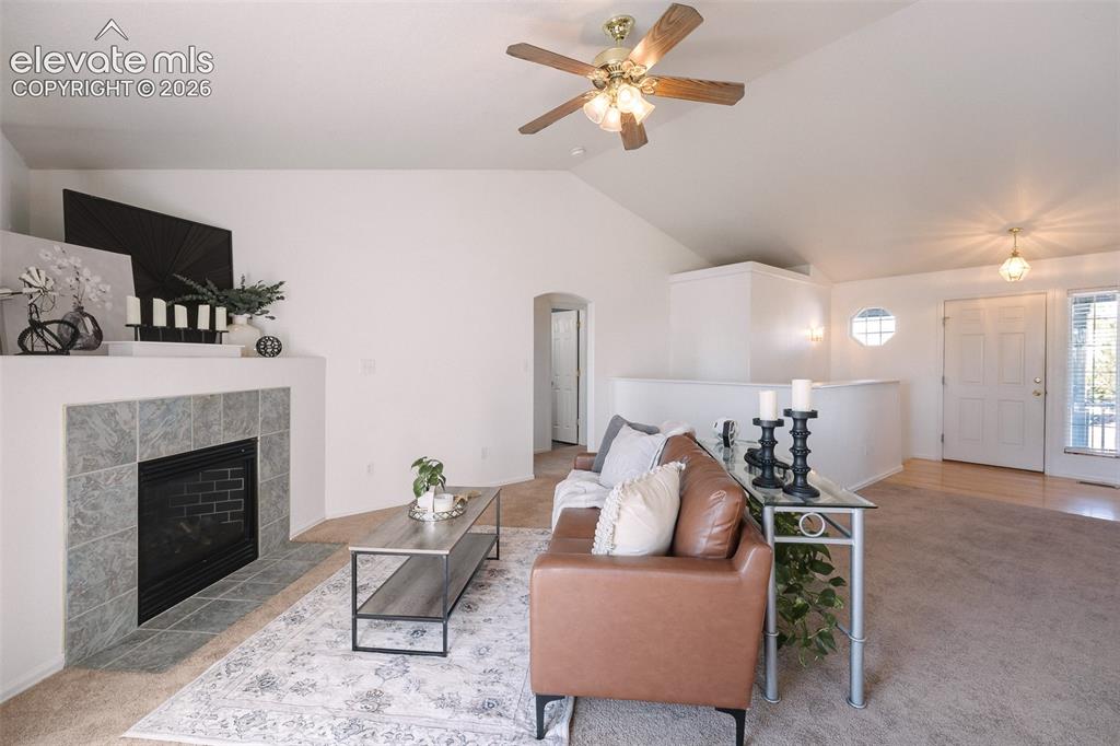 Image 14 of 50: Soaring ceilings, abundant natural light, and a cozy fireplace create a liv