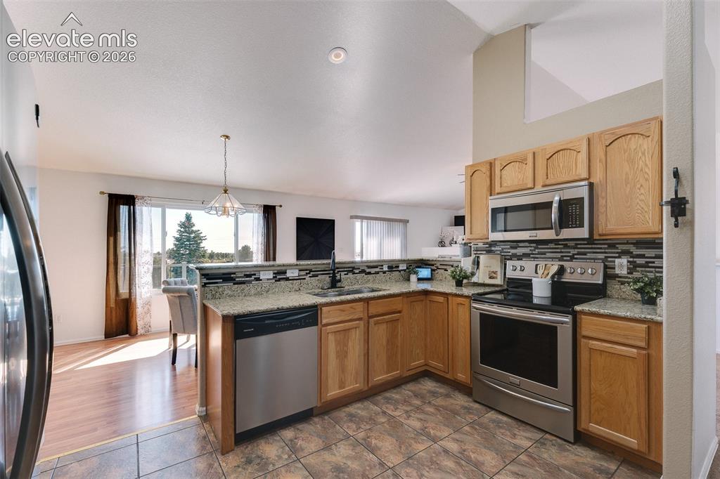 Image 19 of 50: Beautiful kitchen showcasing granite countertops, stainless steel appliance
