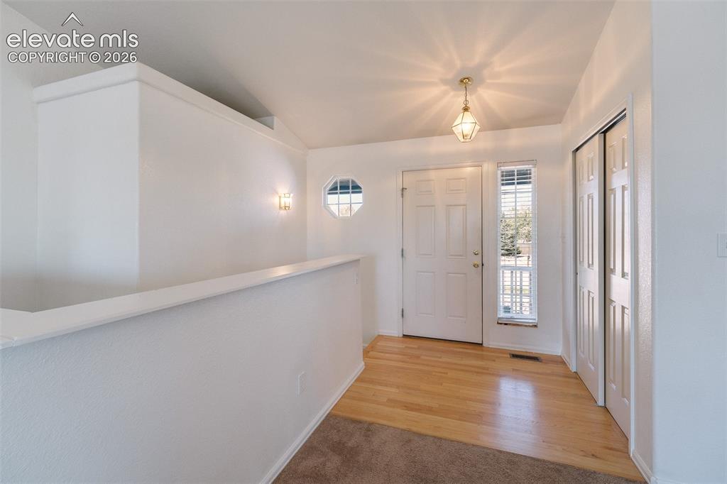 Image 3 of 50: Light and bright front entry with wood flooring, side lite window, attracti
