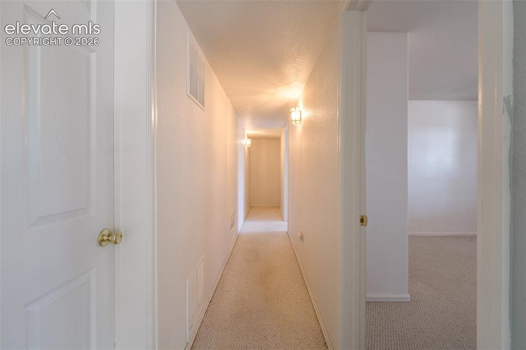Image 34 of 50: Hallway to the Basement Bedrooms.