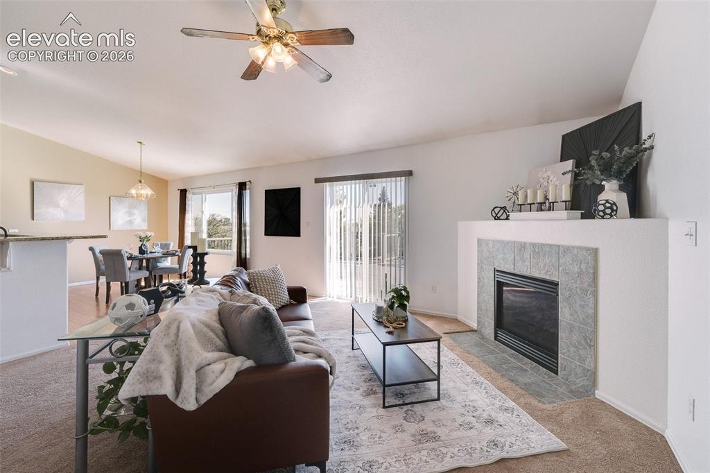 Image 4 of 50: The vaulted Living Room is great for entertaining & features neutral carpet