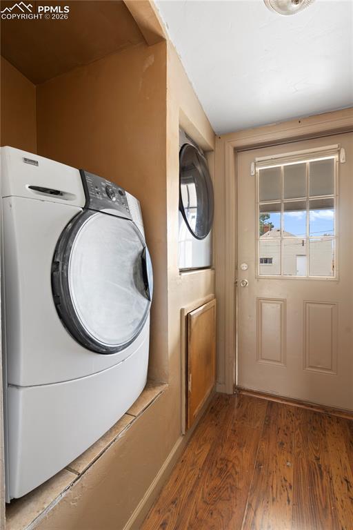 Image 17 of 21: Laundry area featuring washer / clothes dryer and hardwood / wood-style flo