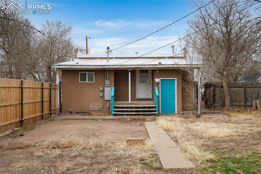 Image 20 of 21: View of front facade with stucco siding, a porch, and entry steps