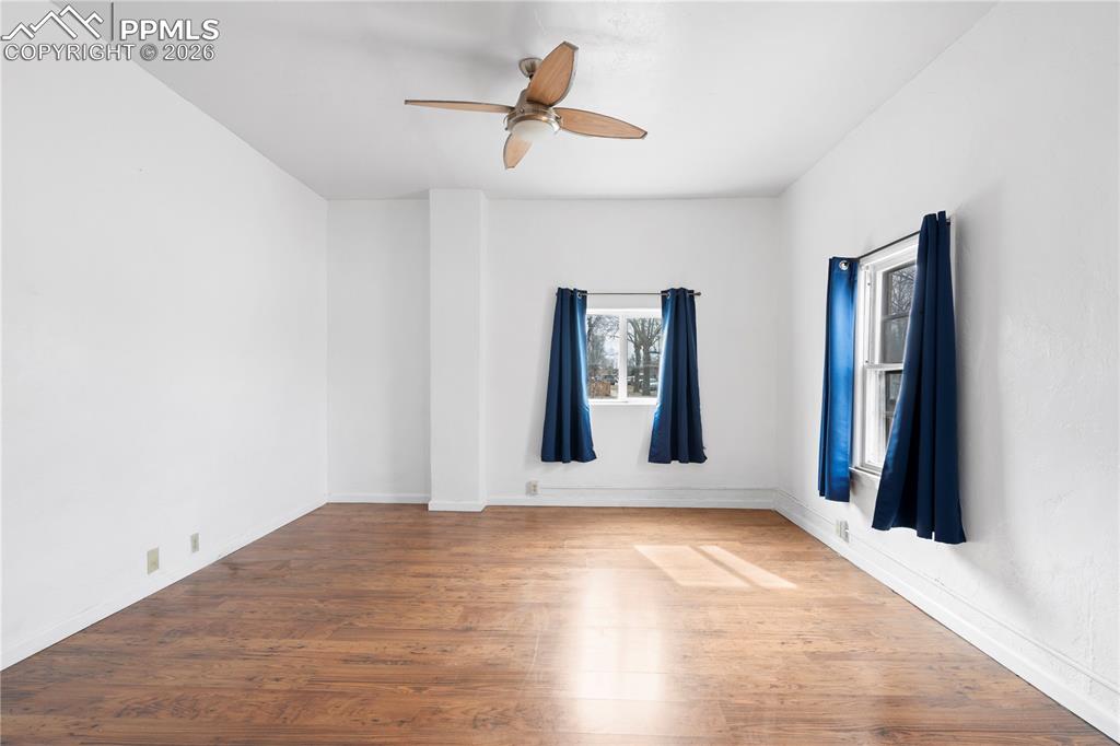 Image 7 of 21: Unfurnished room featuring wood finished floors and a ceiling fan