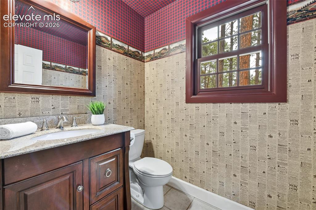 Image 17 of 50: Darling little powder room off kitchen
