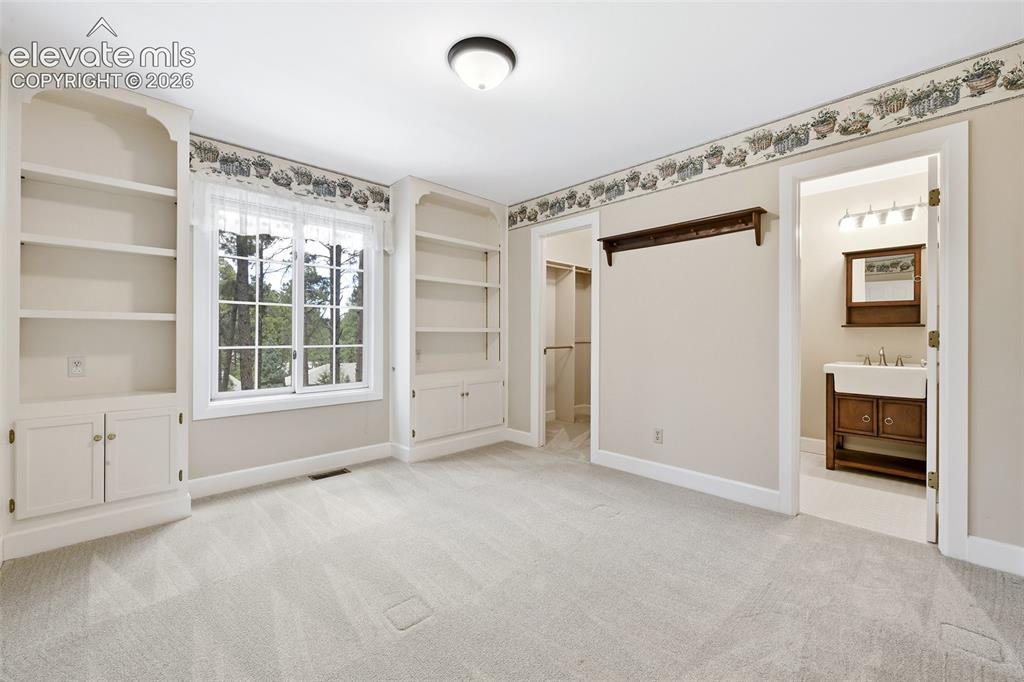 Image 24 of 50: Large second upper bedroom with built-ins, walk-in closet and...