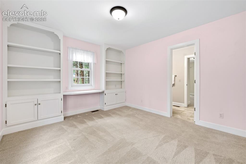Image 26 of 50: Roomy 3rd upper bedroom with built-ins...
