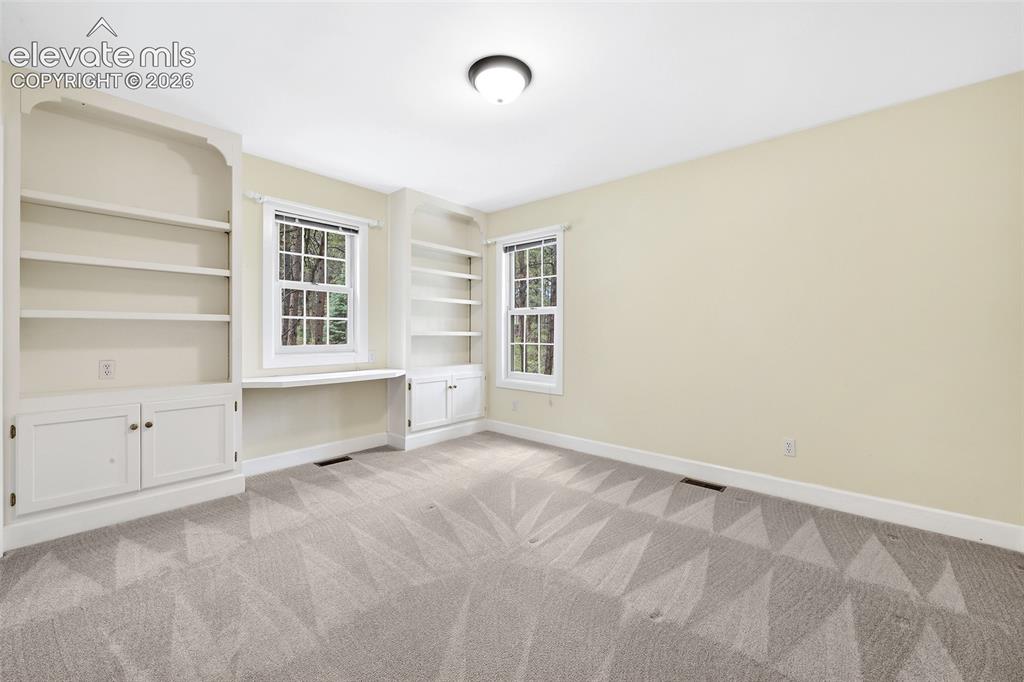 Image 29 of 50: Sizeable 4th upper bedroom with built-ins...