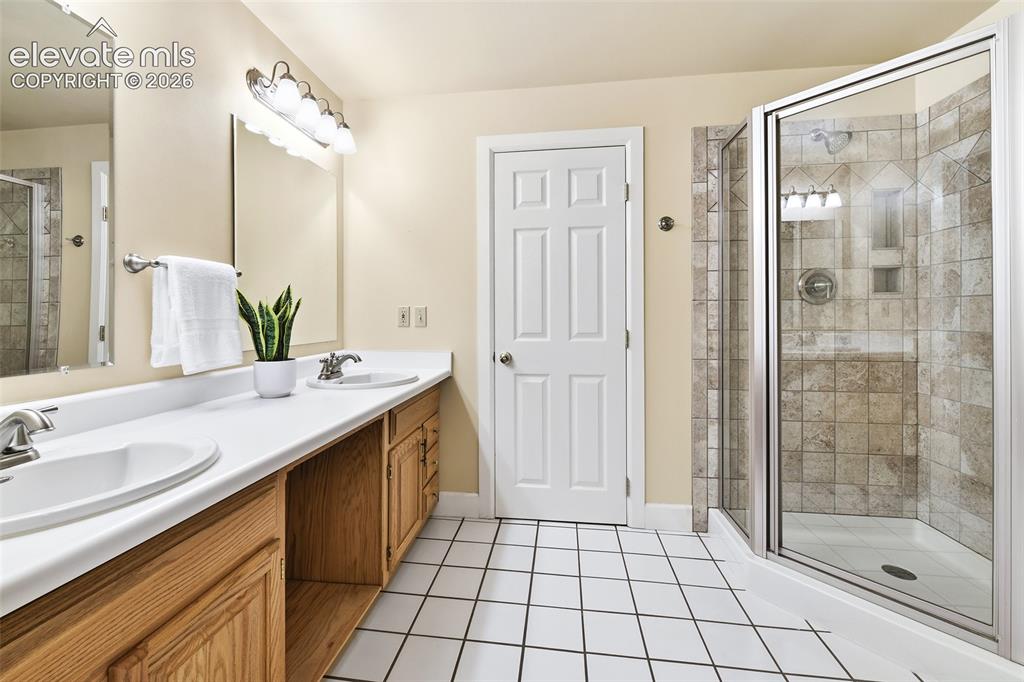 Image 38 of 50: Lower level bath with double vanity
