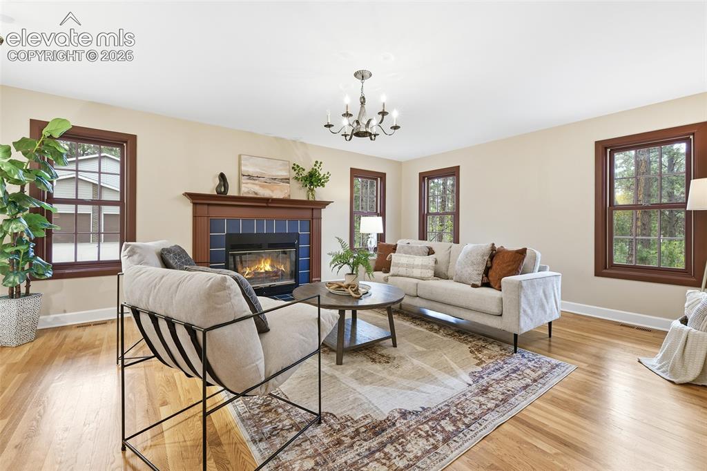 Image 7 of 50: Main level living room with wooded views
