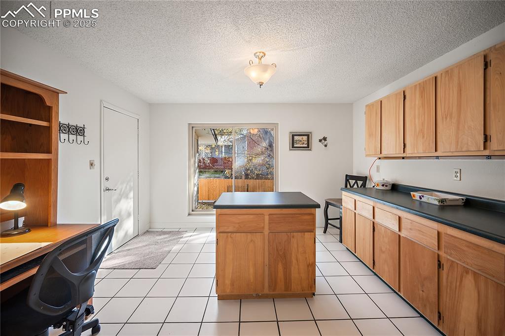 Image 19 of 49: This bonus room features garage access. Tons of counter and cabinet space. 