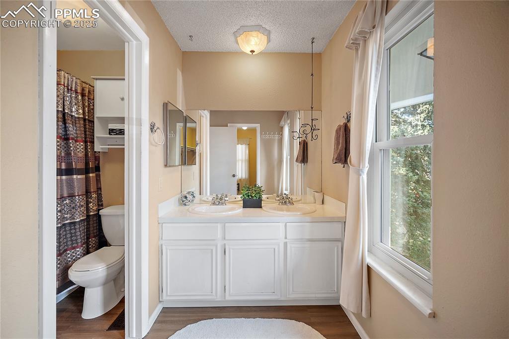 Image 24 of 49: Attached full bath with double vanity. 