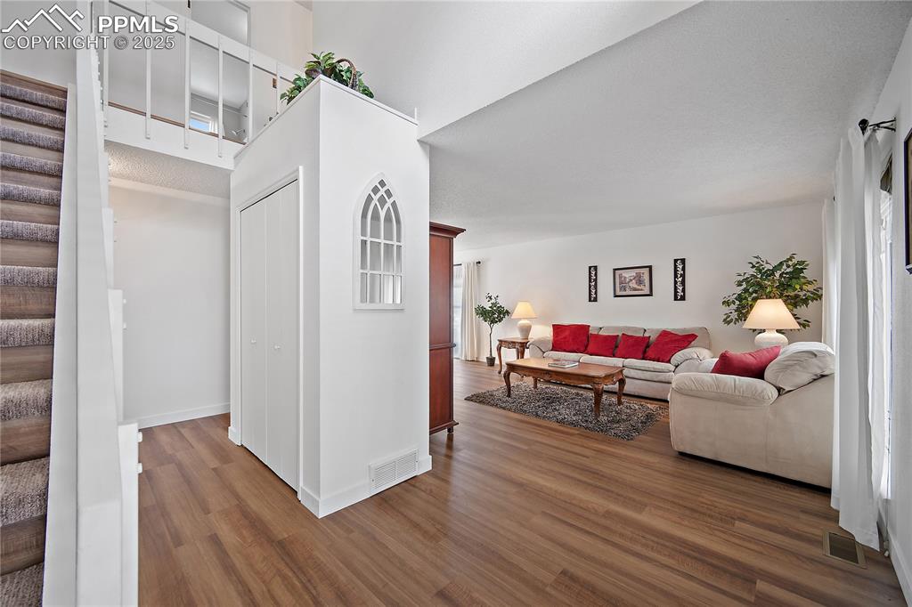 Image 4 of 49: Spacious front entry with large coat closet. To the right is the formal liv