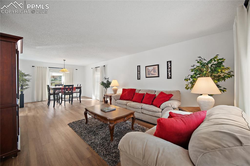 Image 7 of 49: Living room open to the formal dining room. 