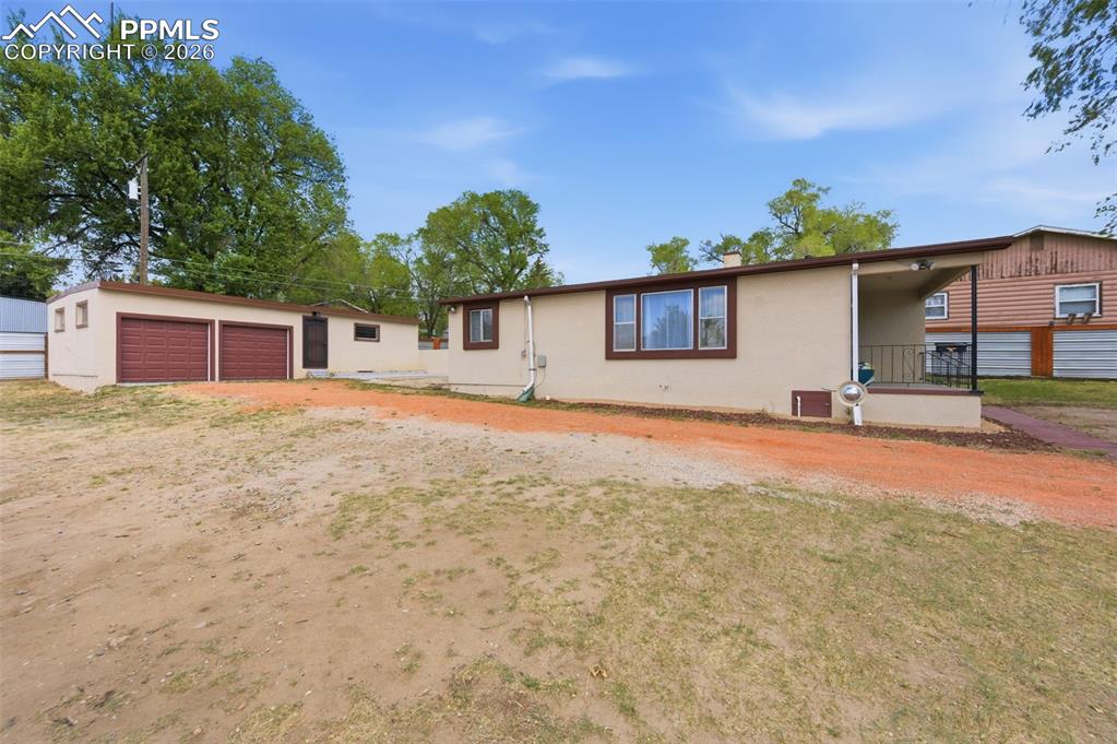 Image 43 of 48: There is a solid perimeter fence around the entire property with a gate.