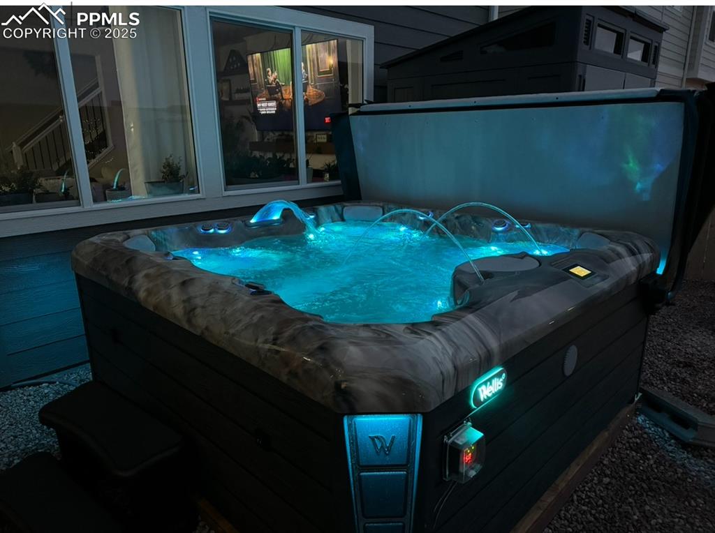 Image 3 of 37: Night-time view of hot tub