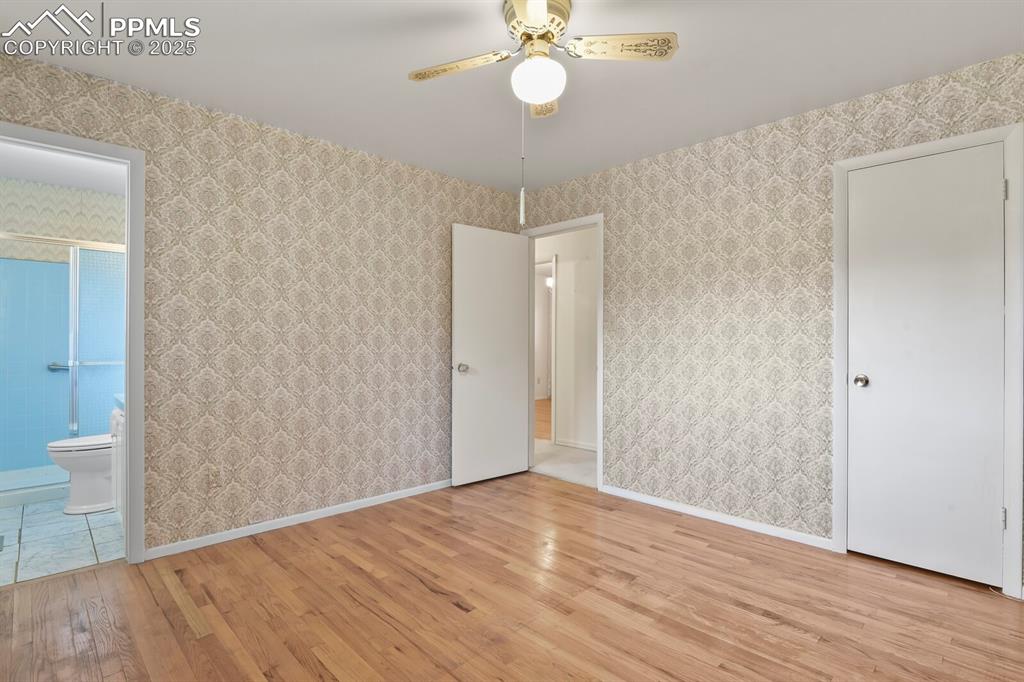 Image 13 of 26: Unfurnished bedroom featuring light wood-style flooring and ensuite bathroo
