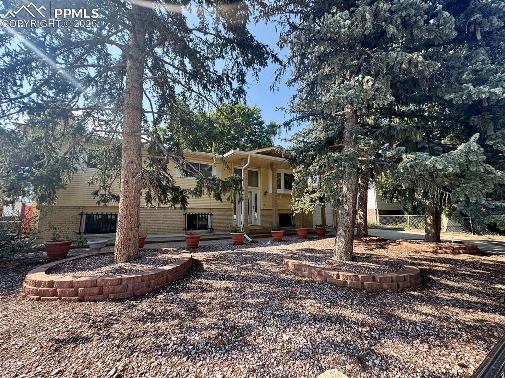 Image 5 of 26: Split foyer home with brick siding