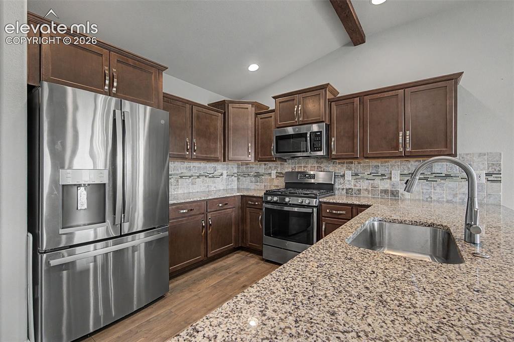 Image 11 of 28: The well-appointed kitchen features stainless-steel appliances, gas range, 
