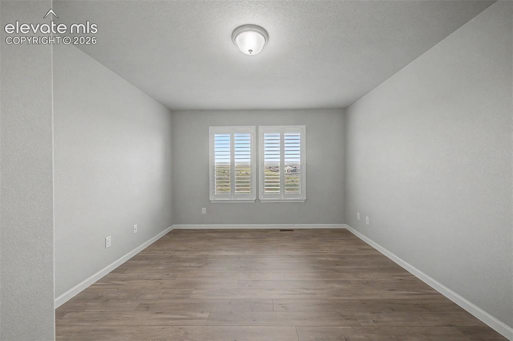 Image 14 of 28: Retreat to the main-level primary suite with ensuite bathroom and walk-in c