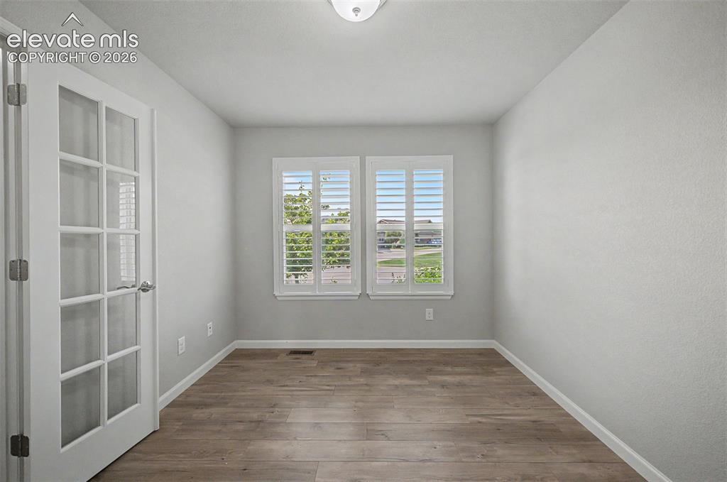 Image 17 of 28: French doors and tons of natural light in the office