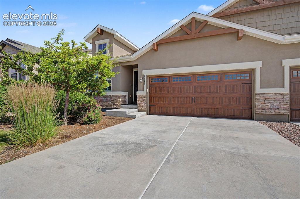 Image 2 of 28: Beautiful landscaping flanks the front path